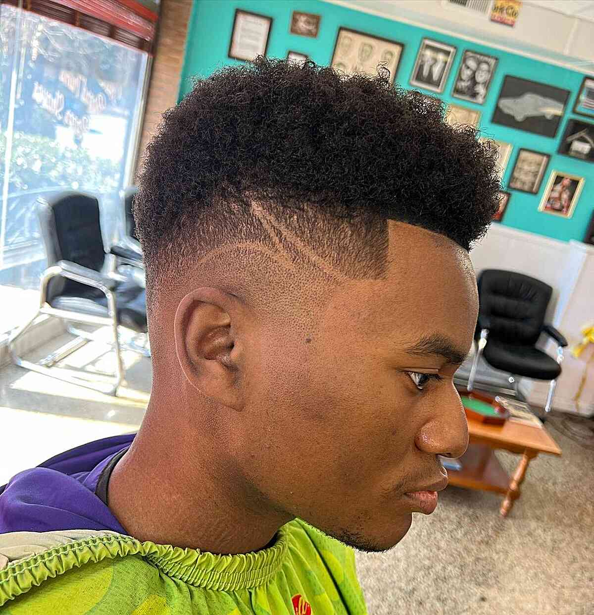 Picture of a black man with a drop fade haircut with a surgical line