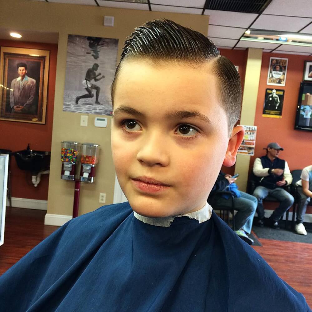 A tapered haircut with a hard part haircut