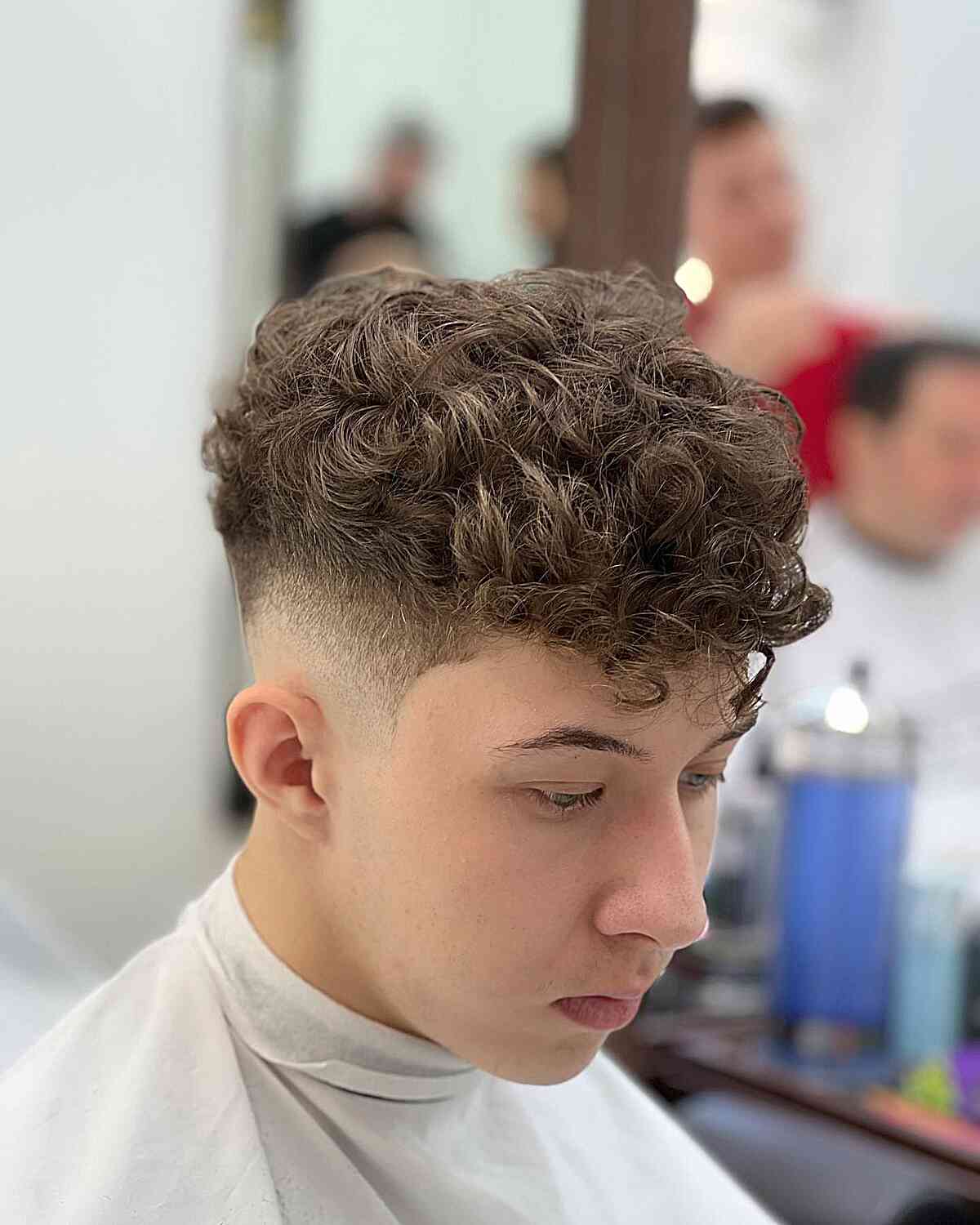 Curly Top with Curly Bangs for Teen Boys with a skin fade