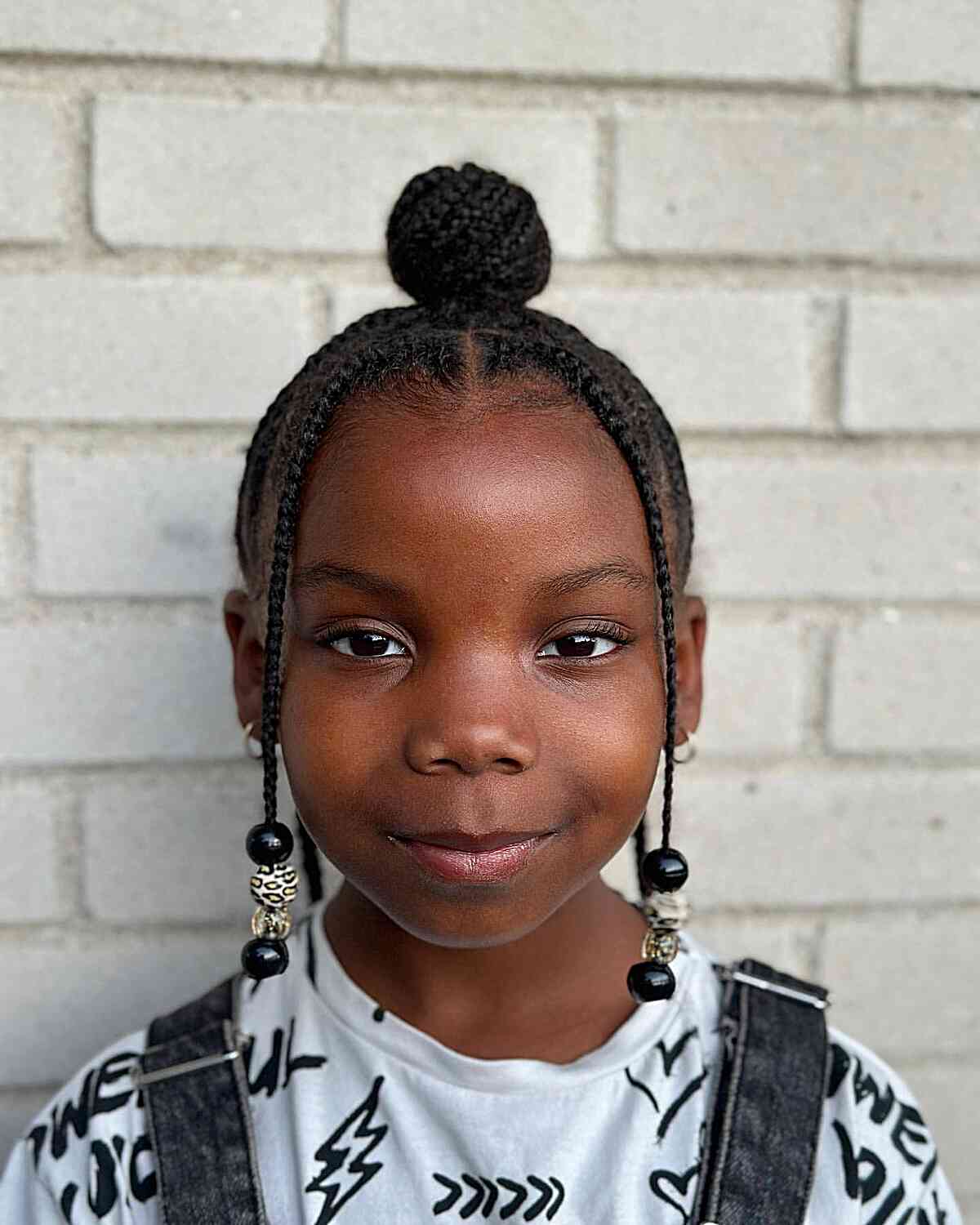Cute Top Bun with Face-Framing Strands for Young Black Girls