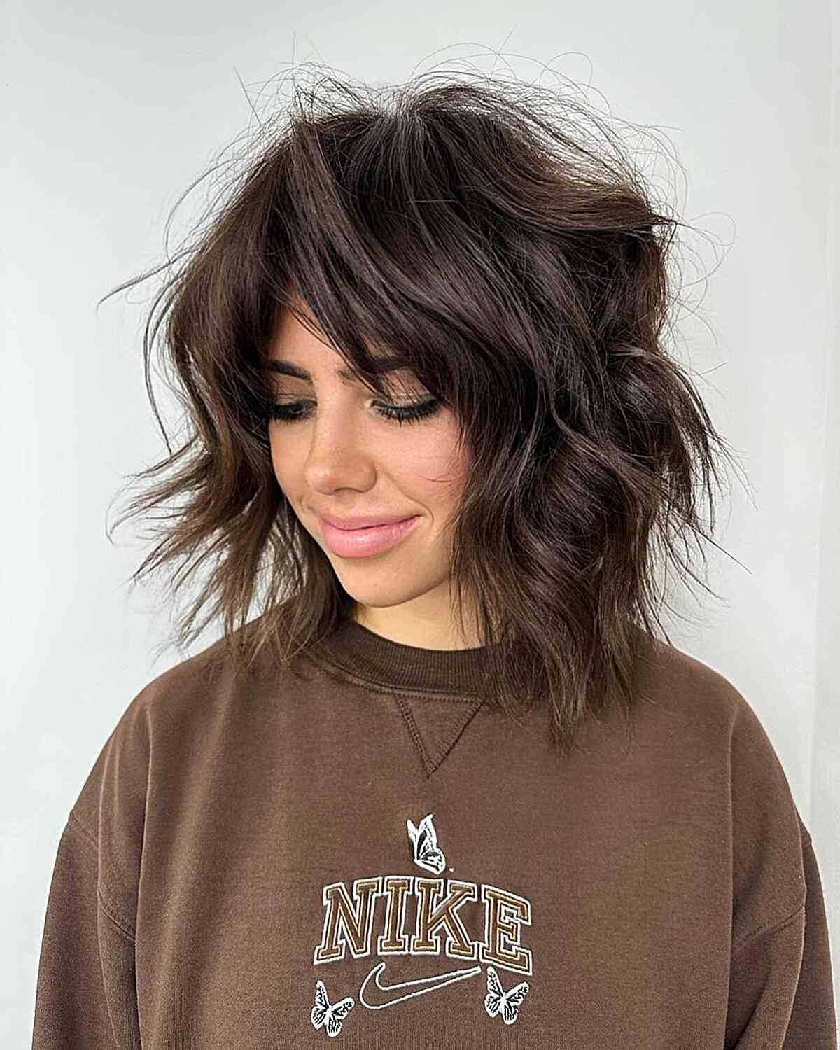 Dimensional Choppy Lob with Layers and curtain bangs