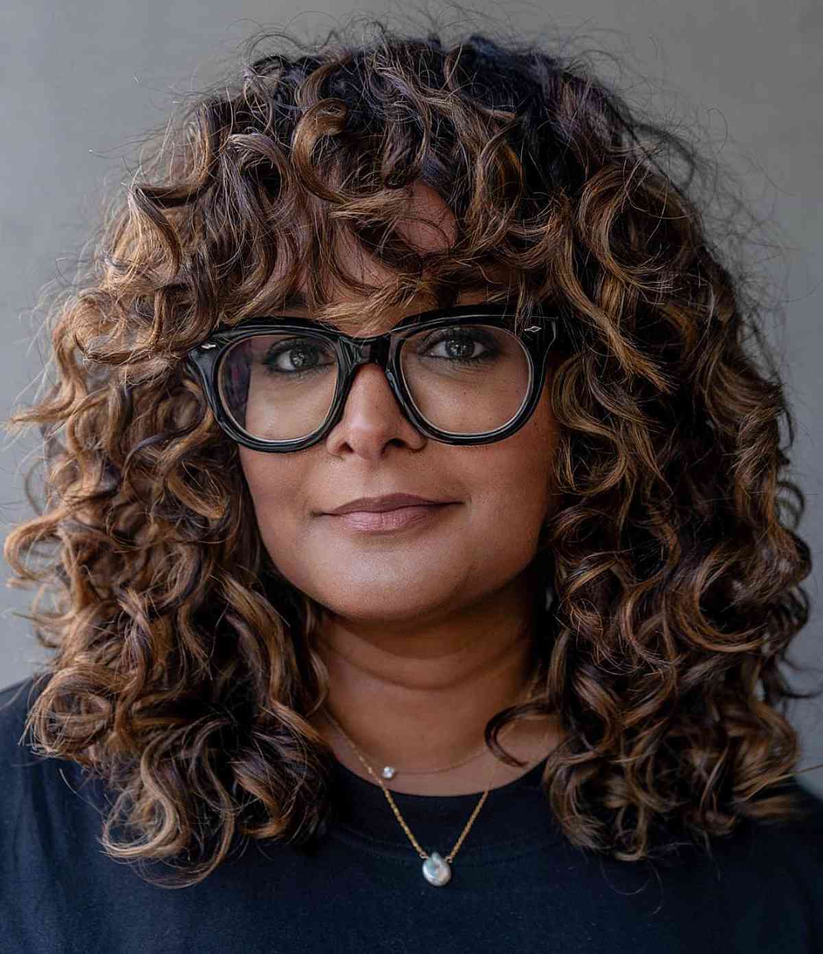 Gorgeous Thick Dark Curls with Highlights for 40-Year-Olds
