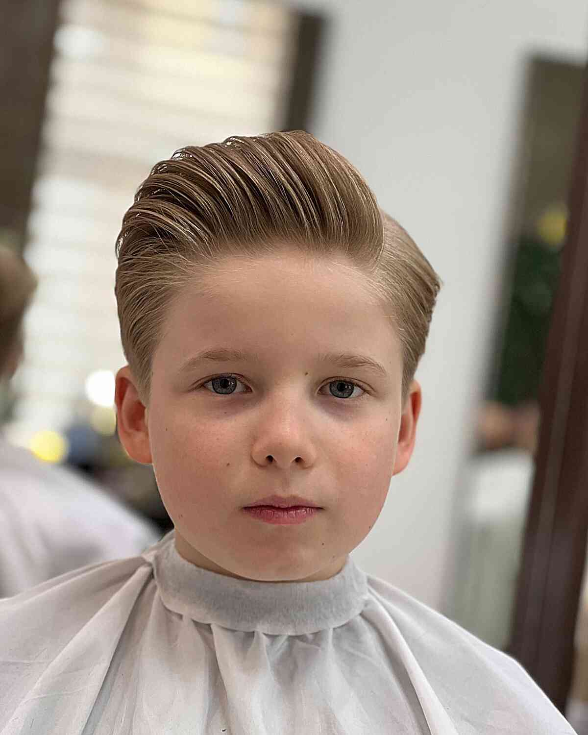 Hard Part Blonde Brushed Back Haircut for Boys with straight hair