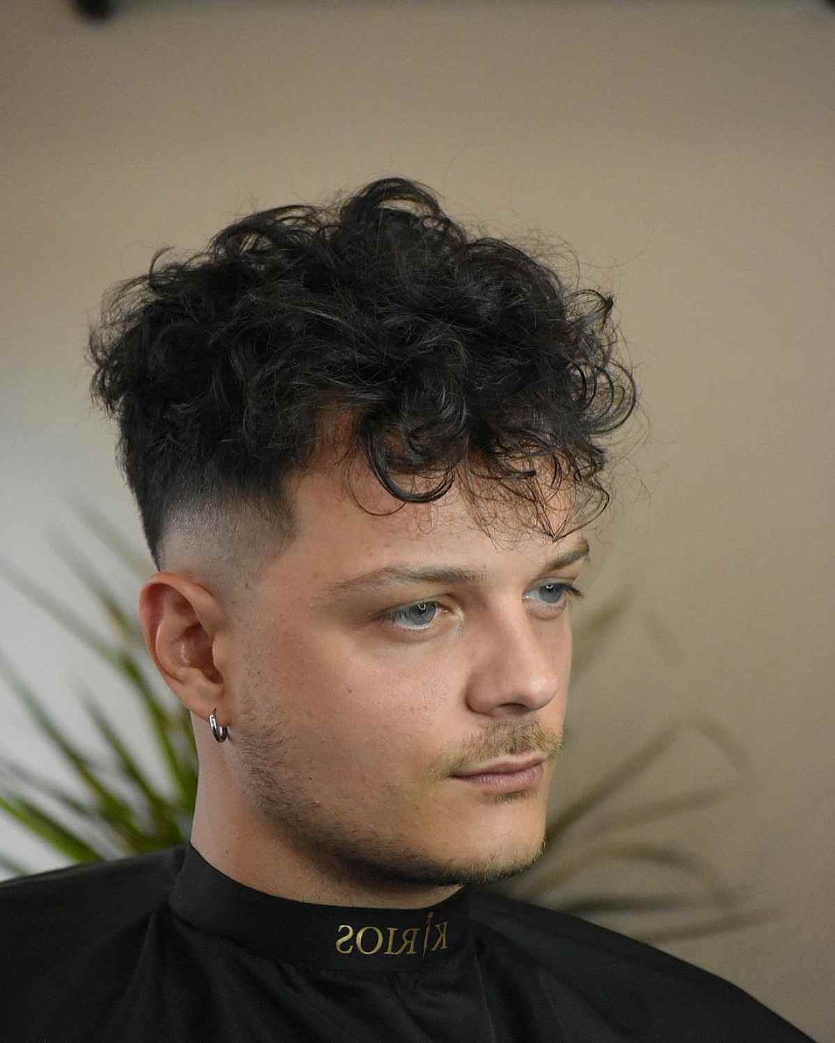Messy curls with a line-up hairstyle for men