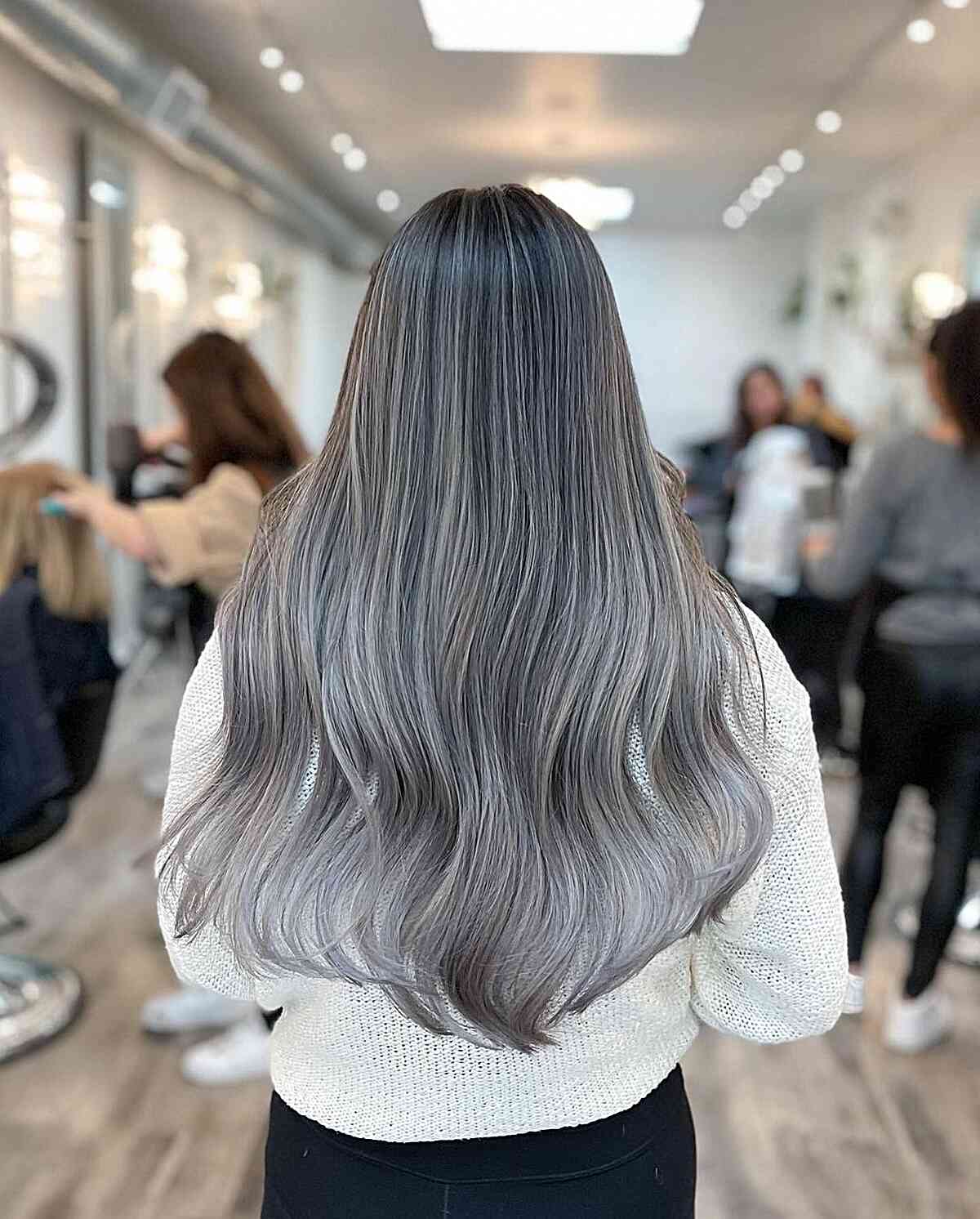 Long Metallic Grey Balayage Hair with Lighter Ends and Soft Waves