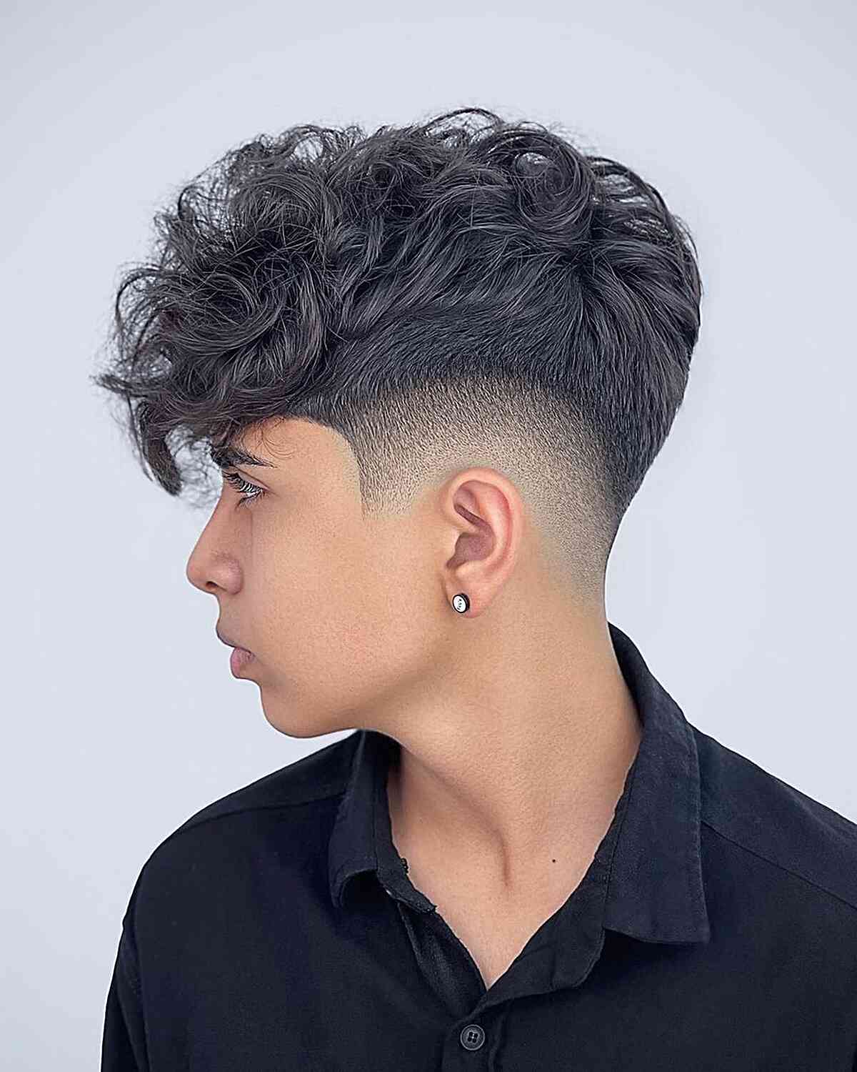 Mid-Fade with a Long Curly Faux Hawk Top for Teen Boys