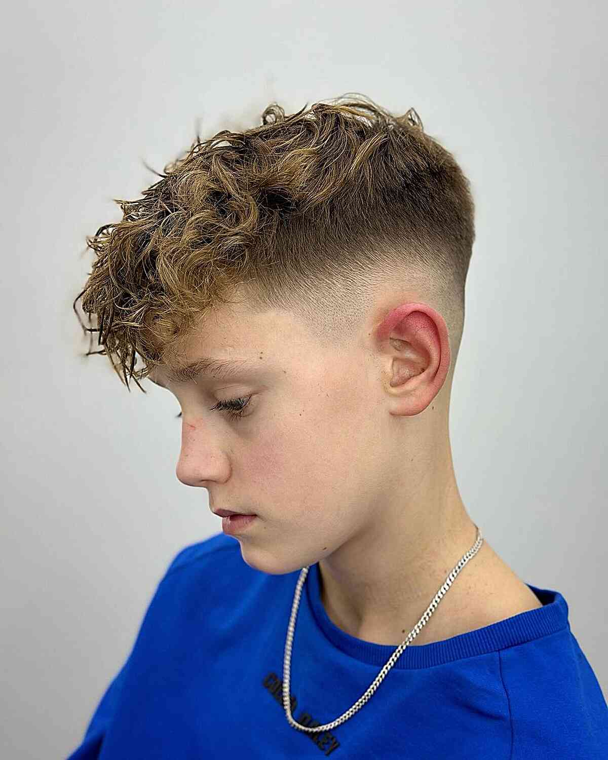 Mid Fade with a Messy, Curly Top for Boys