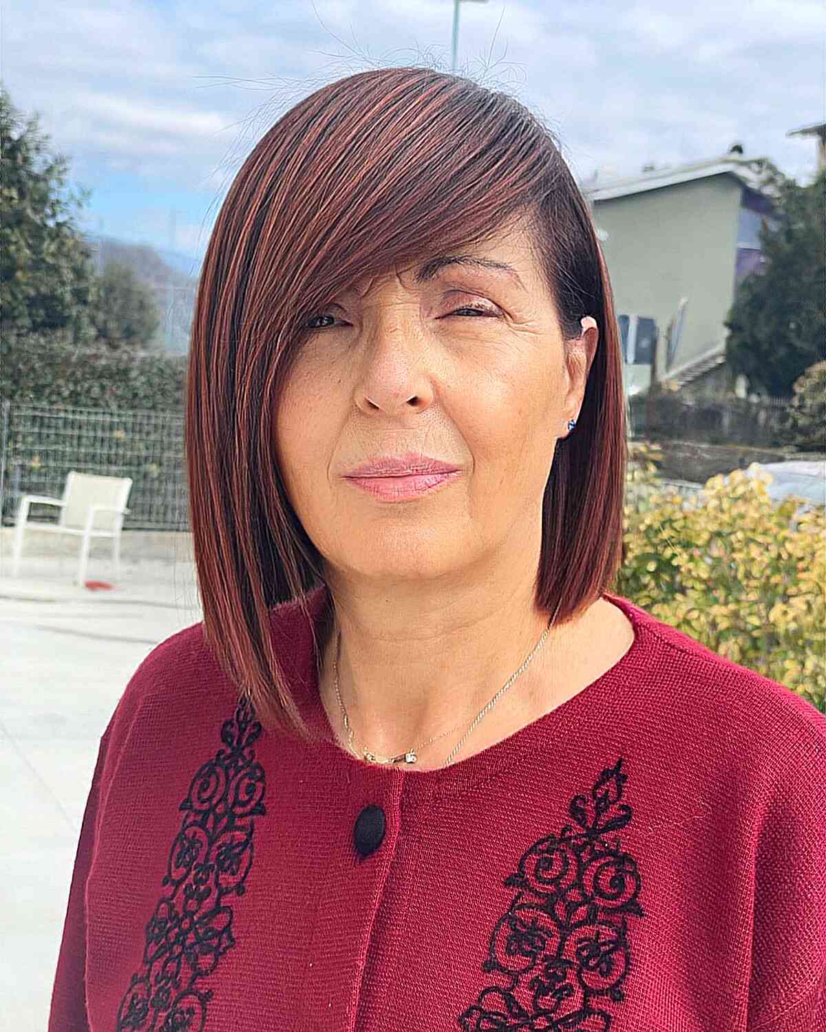 Sleek Asymmetric Lob with Red Highlights for older ladies with fashion