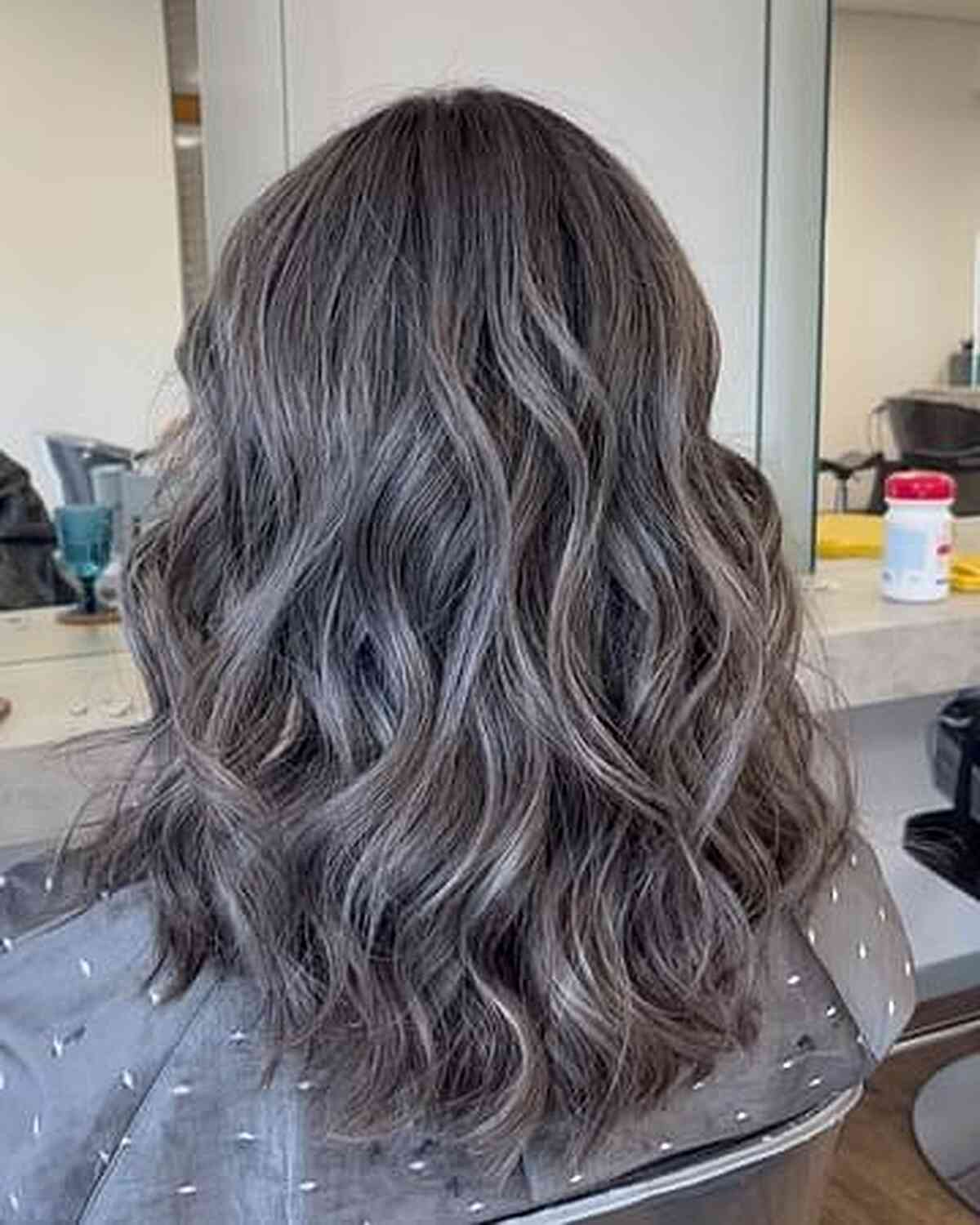 Smokey Silver Balayage Babylights on Medium-Length Wavy Hair