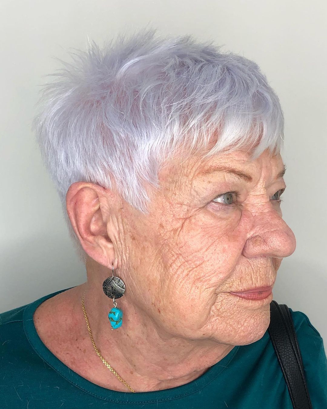 Youthful Woman over 70 with short and choppy gray hair
